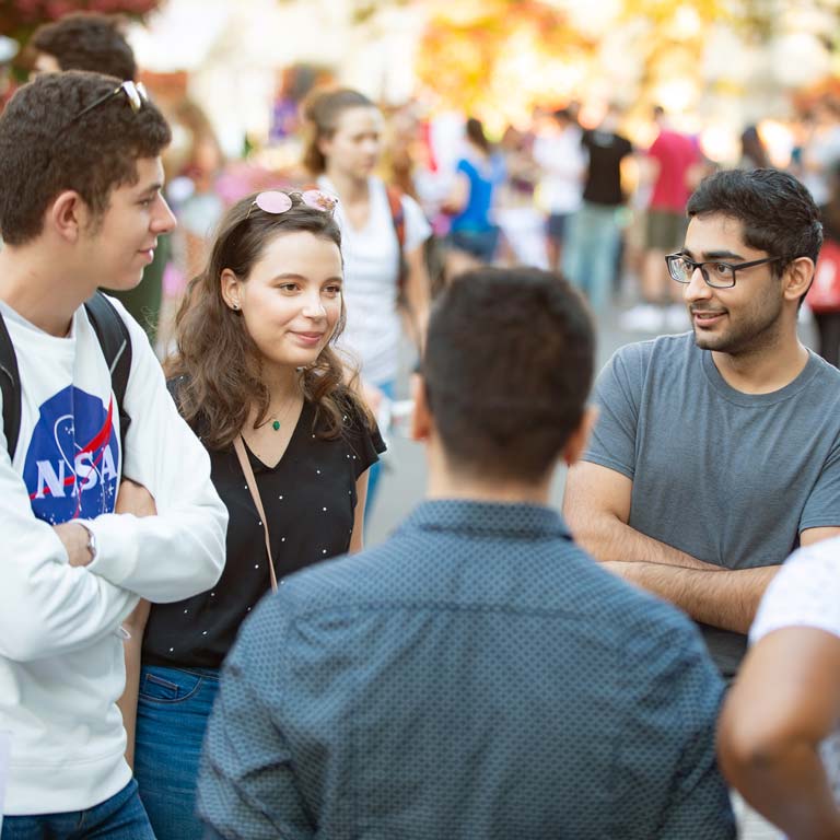 Students with sunglasses gathered at an outdoor event.