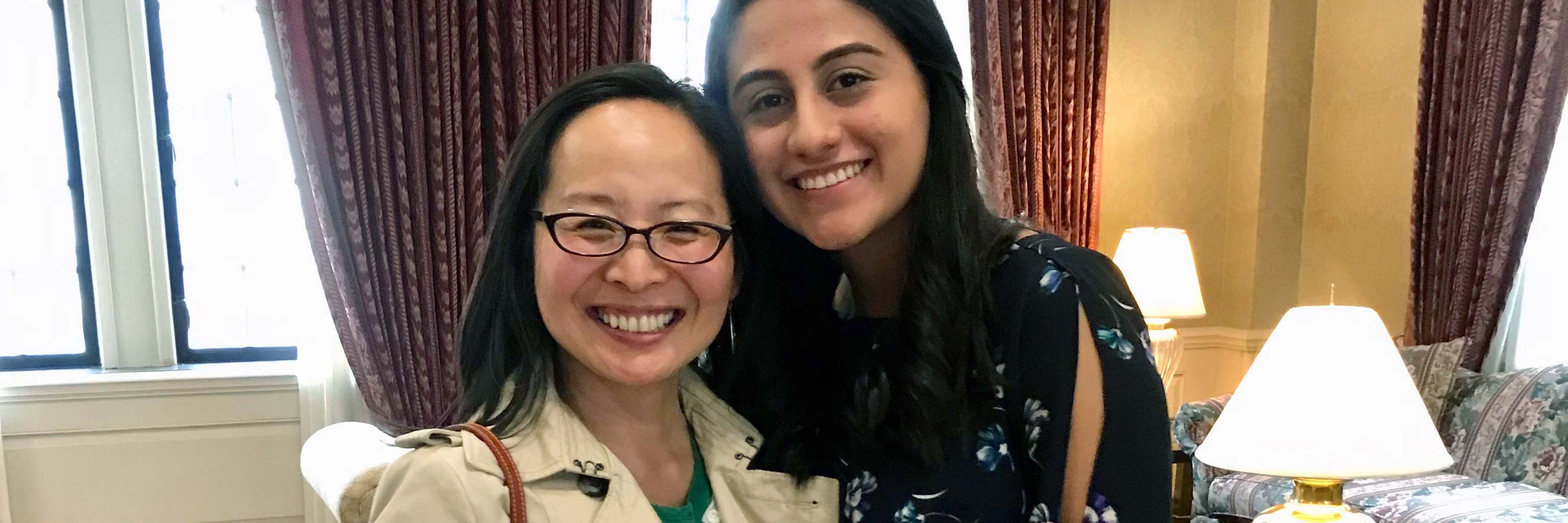 a female faculty member and female student smiling together.
